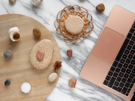 Work from home, desk creative office with laptop, marble, wood and river stonesの写真素材