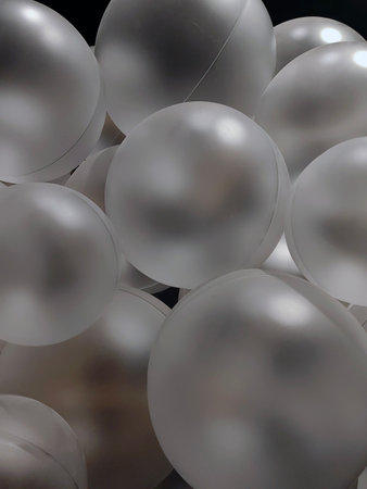 Silver gray balloons, white inflatable balls, plastic ball, background of white and gray circles, festive background of balloons monochrome,の写真素材