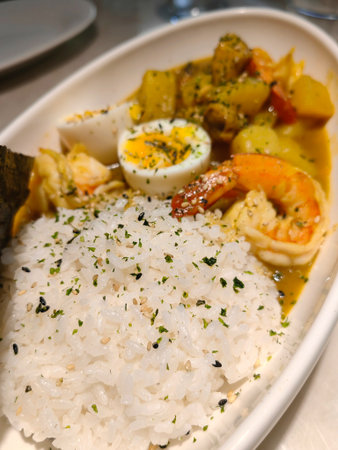 Indian Butter chicken with rice in bowl, spices, black background. Space for text. Butter chicken, traditional Indian dish. Top view. Chicken.. Indian cuisine concept. Overheadの写真素材