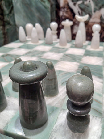 Close-up of a chess board and pieces. Chess game made of stone standing in the openの写真素材
