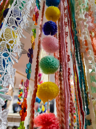 Multicolor string curtain (filament curtain) on window. Home plants in the background. Selective focus. Horizontal home design backdropの写真素材