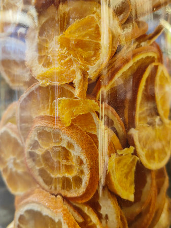 Dehydrated Orange Slices Macro. Photograph of slices of oranges. Segments are seen. Orange or other fruit maybe dried to preserve them. Oranges are dry.の写真素材