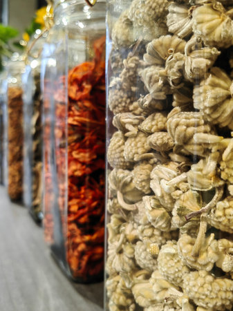 Close up of set with several species or dehydrated fruits in glass pots.の写真素材