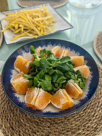 Delicious salad with oranges and arugula on the table. horizontal top viewの写真素材
