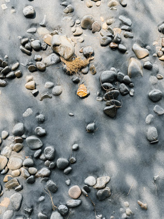 Icelandic landscape of black sand beach. Many pebbles on the black sand beach on the background of the stormy sea in Iceland.の写真素材