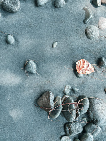 Icelandic landscape of black sand beach. Many pebbles on the black sand beach on the background of...
