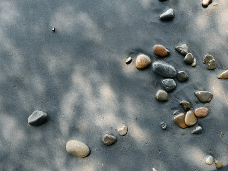 Icelandic landscape of black sand beach. Many pebbles on the black sand beach on the background of the stormy sea in Iceland.の写真素材