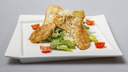 Unusual Caesar Salad On A White Square Plateの写真素材
