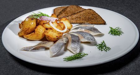 Russian Herring Snack With Baked Potatoes And Black Bread Croutonsの写真素材