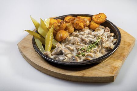 Beef Stef In Creamy Sauce With Baked Potatoes And Pickled Cucumbersの写真素材