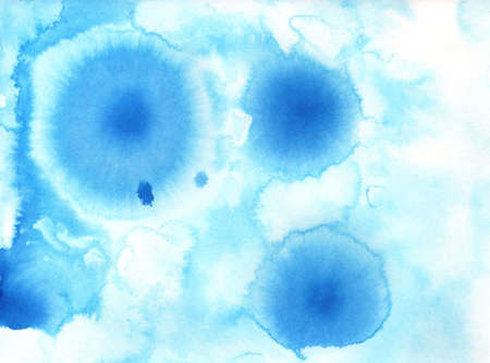 blue ink stains drawn by hands using ink and waterの写真素材