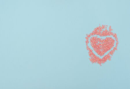 Valentine's Day blue background with lots of pink hearts. Valentine greeting card. Flat lay style.