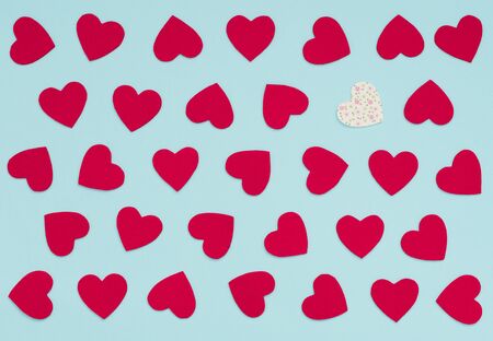 Valentine's Day blue background with lots of felt red hearts and one white with flowers heart....