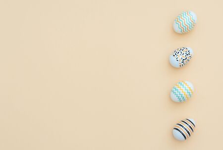 Decorated Easter eggs lie on the yellow background. Happy Easter holiday and minimalism concept....