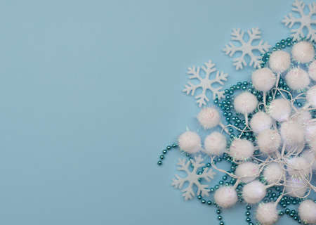 Christmas blue background with Christmas decorations and white snowflakes. New Year greeting card. Flat lay style.の写真素材