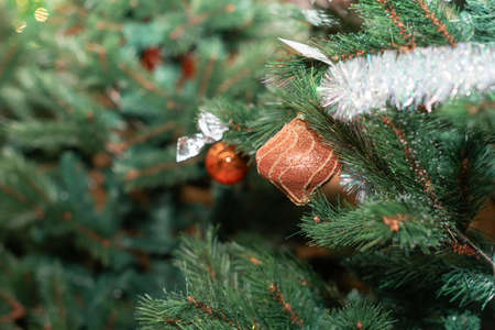 Close-up Christmas orange decoration on the Xmas tree on blurred Christmas background. Happy New Year concept.の写真素材