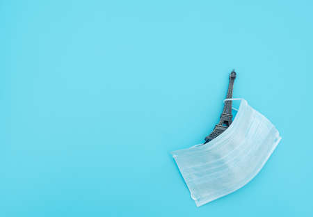 Medical face mask covers travel attraction on blue background. Biohazard, 2019-nCoV, COVID-19. The...