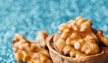 Delicious walnut on blue blurred background. Selective focus. Food macro concept. Tasty and healthy nuts. Card, poster for menu. Image for notebook cover or puzzles.の写真素材