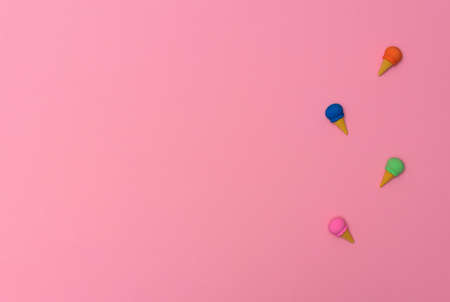 Small erasers in the form of ice cream on pink background. Summertime, minimalism concept. Flat lay...