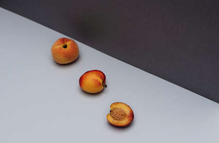 Summer scene with peach and nectarines on white and dark grey background. Summertime concept. Card...
