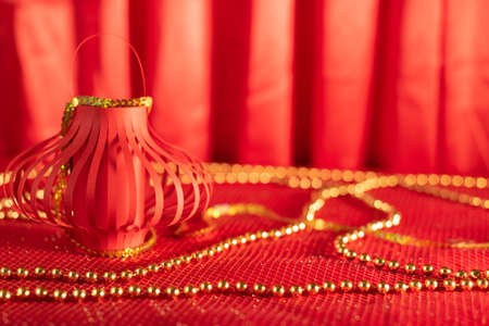 Red defocused abstract background with Red Chinese paper lantern close up with selective focus and...