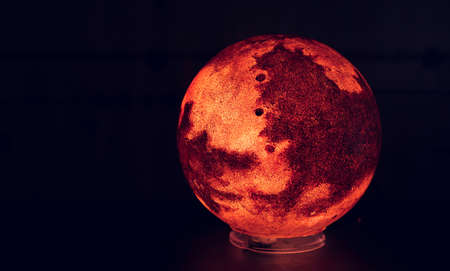Red planet model close up on black background. Space conceptの写真素材