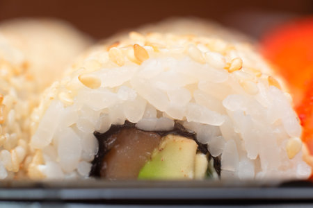 Delicious Japanese rolls with salmon, avocado, cucumber close up with selective focus. Asian food concept. Healthy eating.の写真素材
