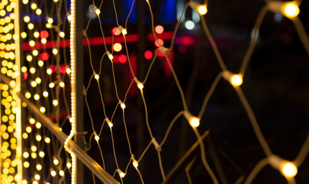 Beautiful defocused background with golden Christmas illumination at night. Decoration close up on...