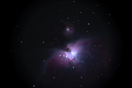 Night sky background with bright Orion nebula on black sky with stars. Astro photo on winter night with soft selective focus. High quality photoの写真素材