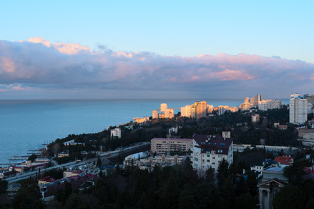 View of Sochi city on a sunny winter day with bright blue sky with white clouds and blue sea during beautiful sunrise. Nature background with selective focus. Travel concept. High quality photoの写真素材