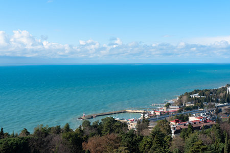 View of Sochi city on a sunny winter day with bright blue sky with white clouds and blue sea. Nature background with selective focus. Travel concept. High quality photoの写真素材