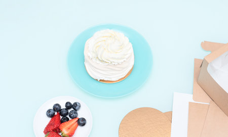 Ingredients for Pavlova cake: strawberries, blueberries and meringue with selective focus. Homemade pastry, delicious sweets concept. High quality photoの写真素材