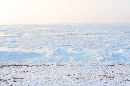 Winter beautiful landscape of frozen Japan Sea covered with ice and snow on a sunny day. Beauty of...