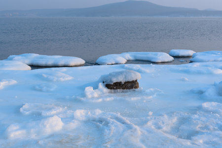 Winter beautiful landscape of frozen Japan Sea covered with ice and snow on a sunny day. Beauty of nature concept. Postcard from Russia with selective focus. High quality photoの写真素材