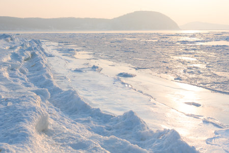 Winter beautiful landscape of frozen Japan Sea covered with ice and snow on a sunny day. Beauty of nature concept. Postcard from Russia with selective focus. High quality photoの写真素材
