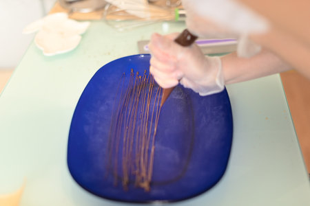 Process of making chocolate nest for decorating homemade Easter cake close up with selective focus. Happy Easter concept. Process of cooking at home. High quality photoの写真素材