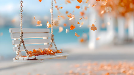 A white swinging bench is adorned with colorful autumn leaves, gently falling around it, set against a tranquil water backdrop, evoking a peaceful and reflective ambiance in natureの素材