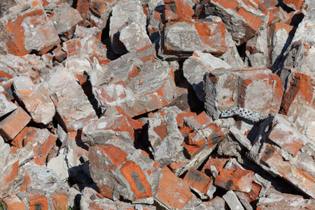 Pile of broken red bricks on construction site, garbage