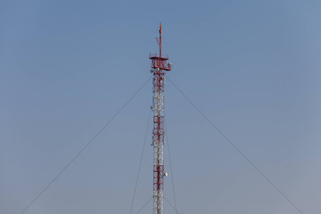 Cellular communication antena and cloudy sky background