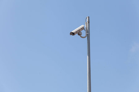 Laterally camera on a post in blue sky