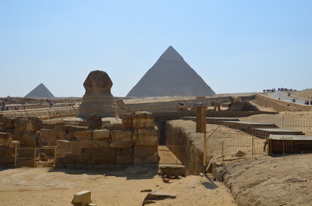 Beautiful profile of the Great Sphinx including pyramids of Menkaure and Khafre in the background on a clear sunny blue sky day in Giza Cairo Egypt