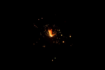 Burning sparkler isolated on black background in darknessの写真素材