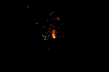 Burning sparkler isolated on black background in darknessの写真素材