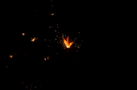 Burning sparkler isolated on black background in darknessの写真素材