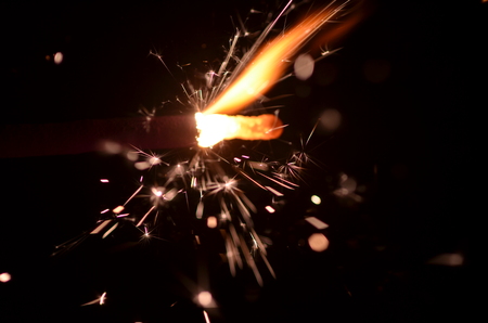 Burning sparkler isolated on black background in darknessの写真素材