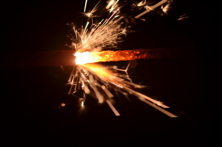Burning sparkler isolated on black background in darknessの写真素材