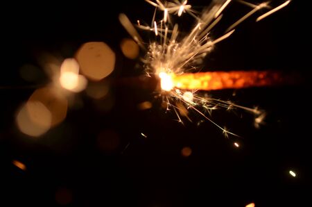 Burning sparkler isolated on black background in darknessの写真素材