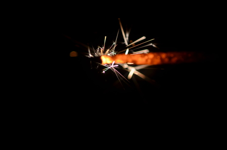 Burning sparkler isolated on black background in darknessの写真素材