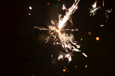 Burning sparkler isolated on black background in darkness