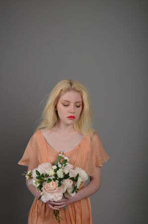Girl in lilac dress posing in photo studioの写真素材